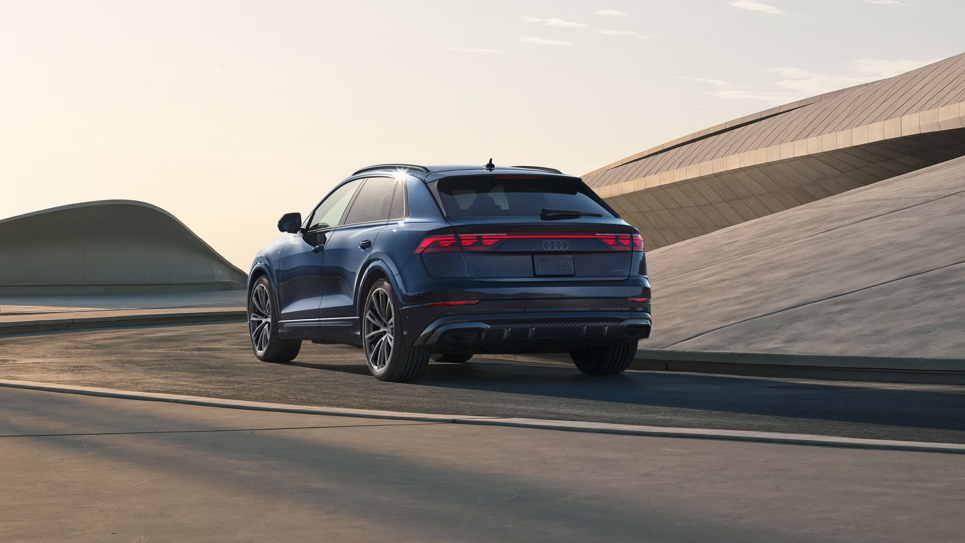 Rear view of an Audi Q8 accelerating.